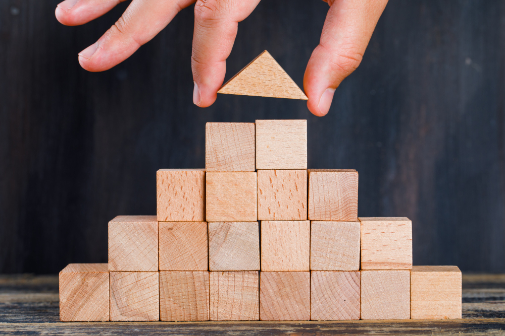 Building the Foundations of Your New Company Wooden building blocks representing the foundations of a new company
